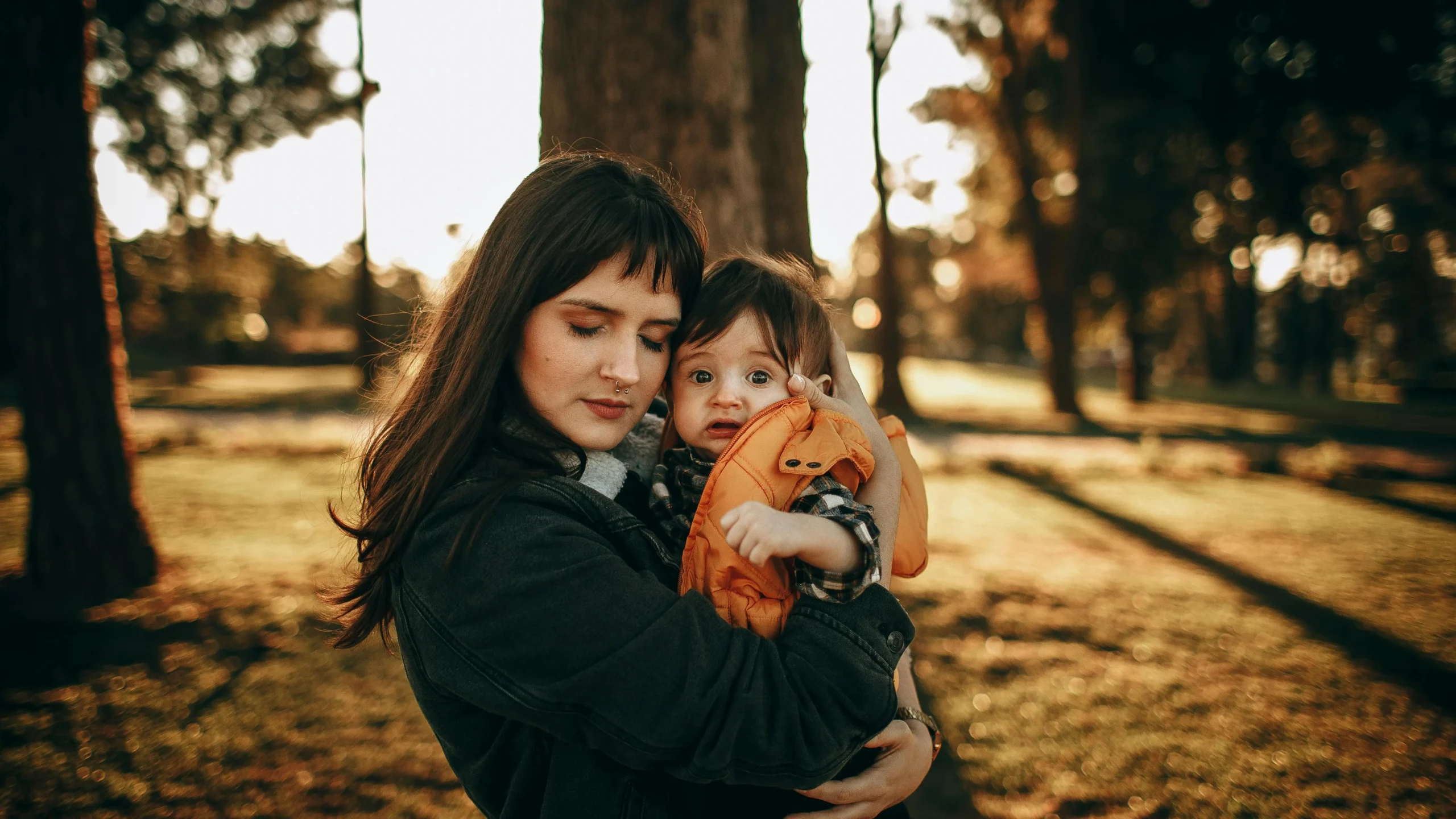 Mother breastfeeding son in park, highlighting breastfeeding and vaginal dryness