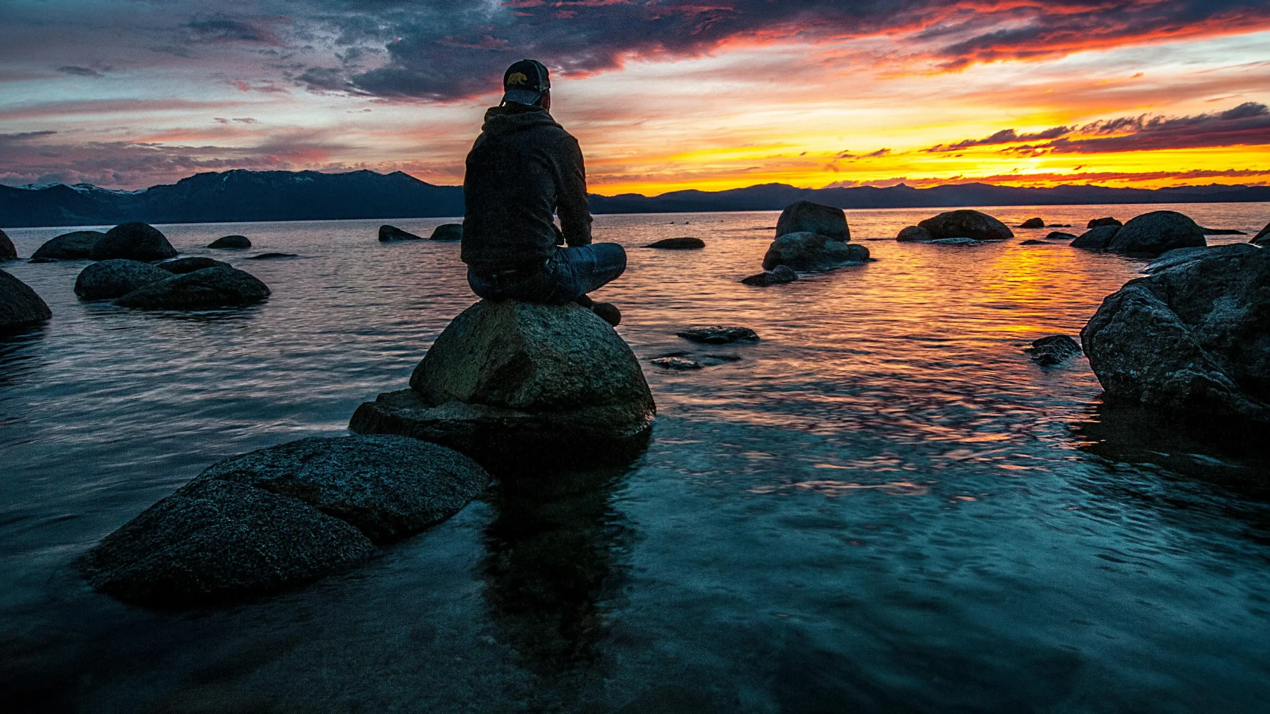 Woman sitting on rock, contemplating menopause and vaginal odor.