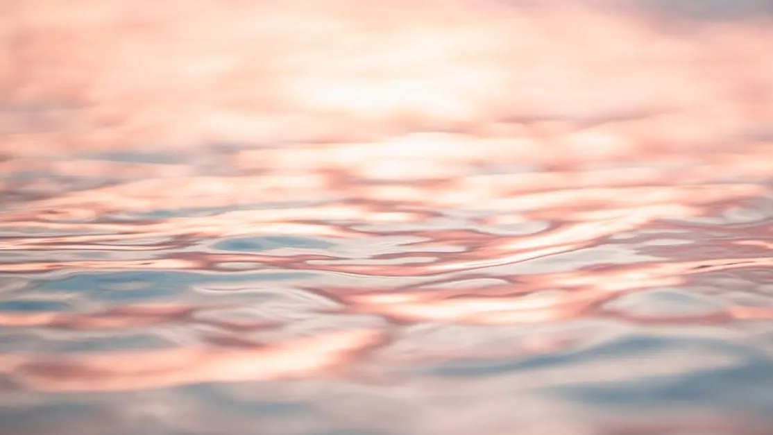 Rippling seawater reflecting pink evening sky, symbolizing clitoral itching and menopause.