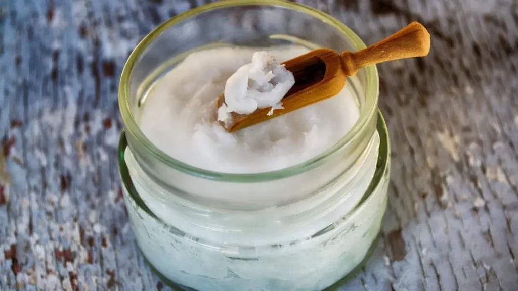 Coconut oil in a clear glass container for vaginal dryness.