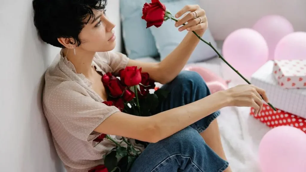 Woman holding flowers experiencing menopause and belly bloat near balloons