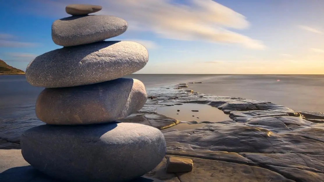 Stacked stones symbolizing balance, related to yeast infection probiotic insert.