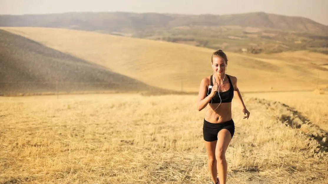 Happy young woman running in a field, symbolizing the benefits of HRT for women.