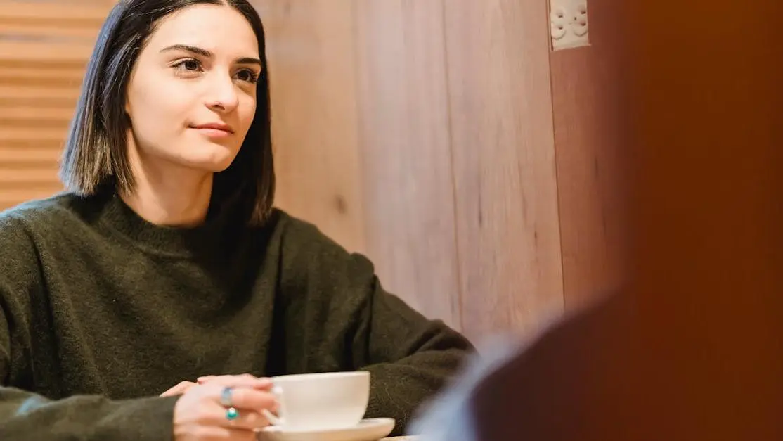 Woman drinking coffee to manage hot flashes