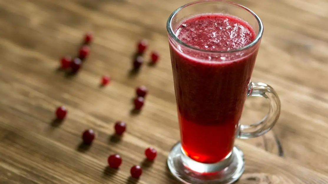 Glass of cranberry juice on a wooden table