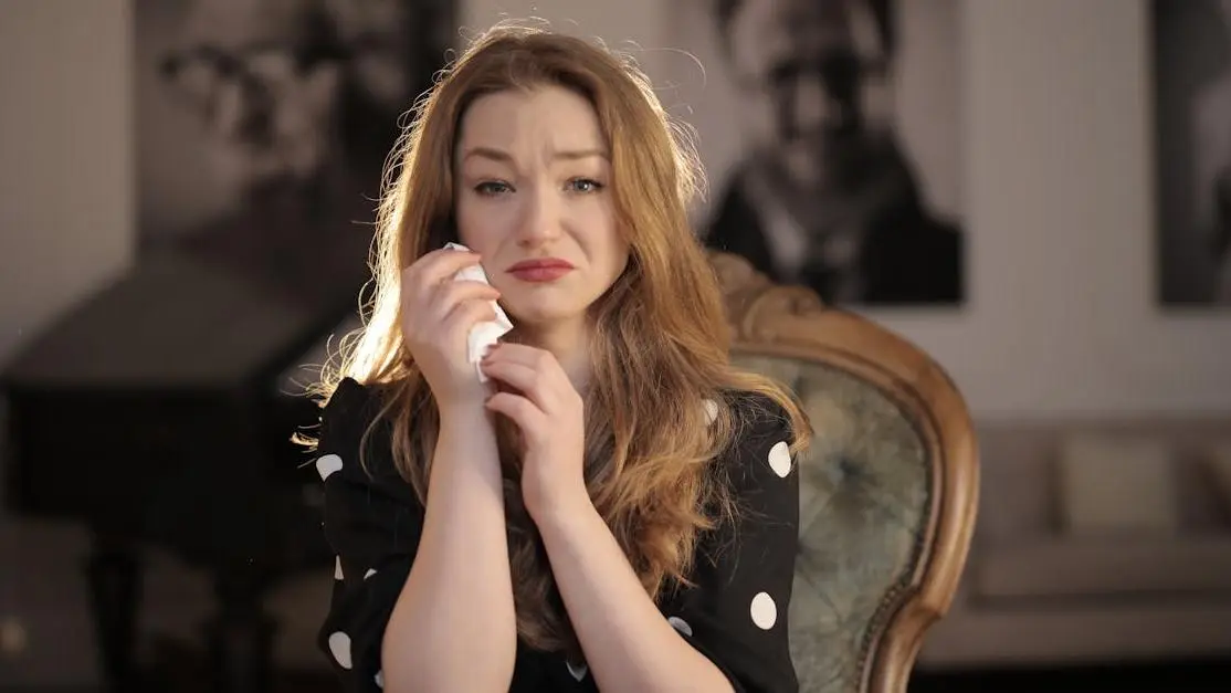 Sad woman experiencing hair thinning and loss in black and white polka dots