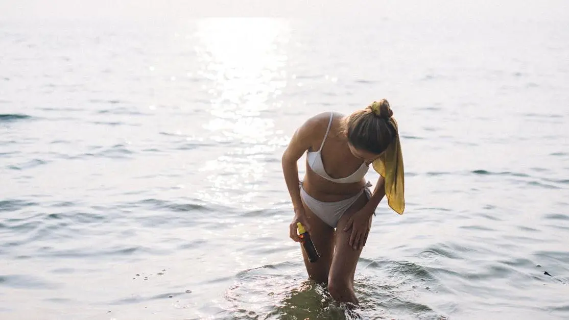 Woman using hydrogen peroxide for bacterial vaginosis treatment in water.