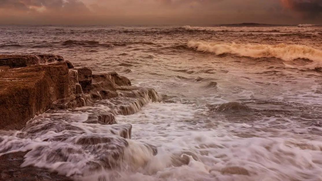 Sunset over ocean waves, illustrating the calming effect amidst irritability hormones.