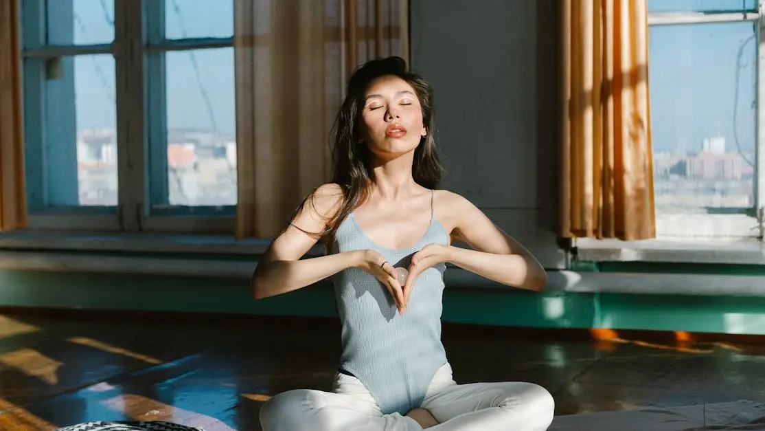 Asian woman meditating with stone, feeling irritable during period