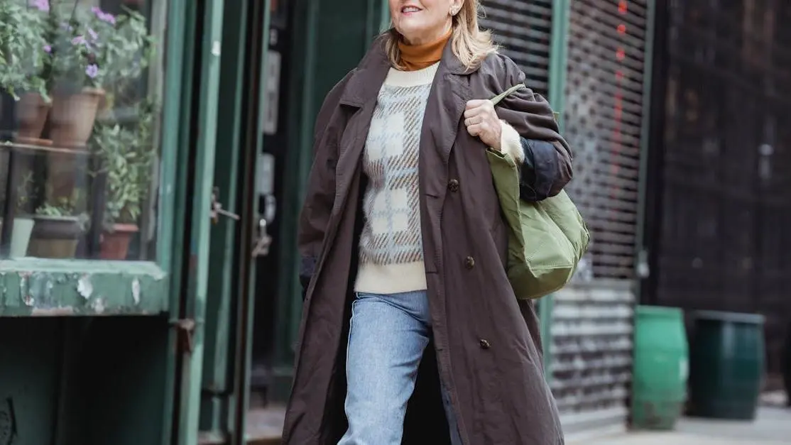 Middle-aged woman in coat walking outdoors, highlighting Menopause and Skin Health