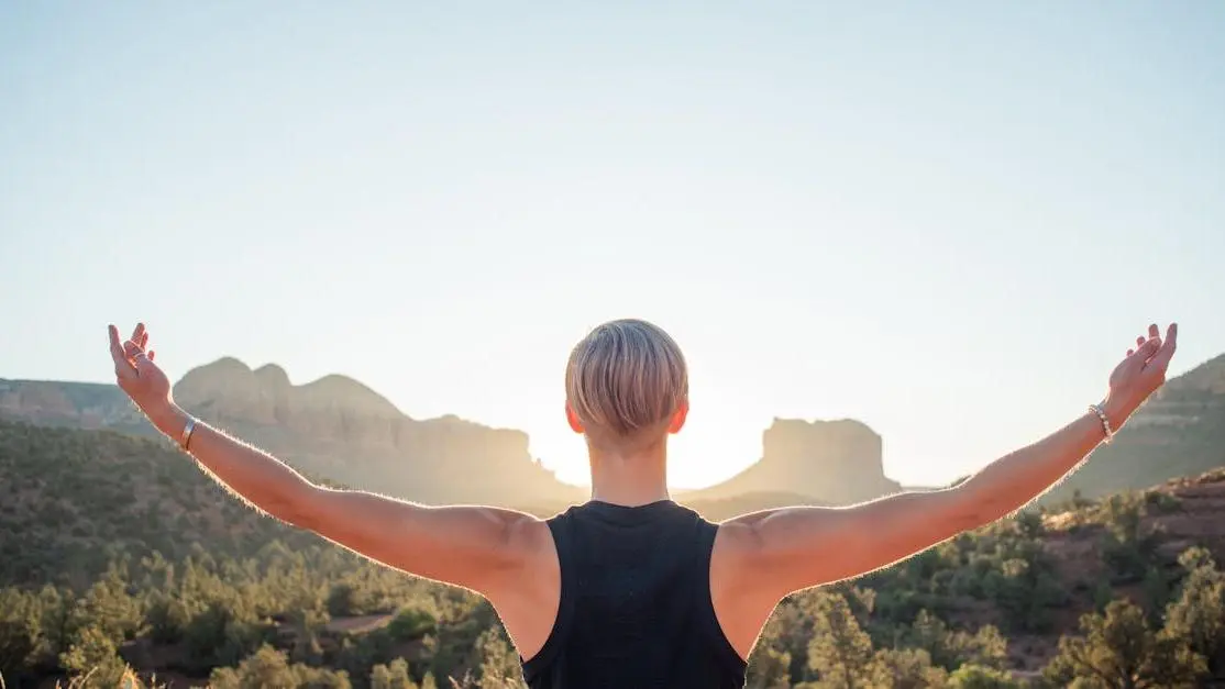 Woman embracing tranquility at sunrise, symbolizing menopause irritability natural treatment