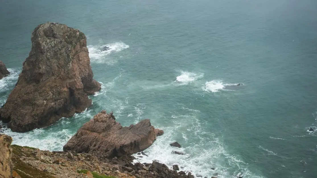 Foamy waves splashing against a rocky cliff, representing menopause mood swings.