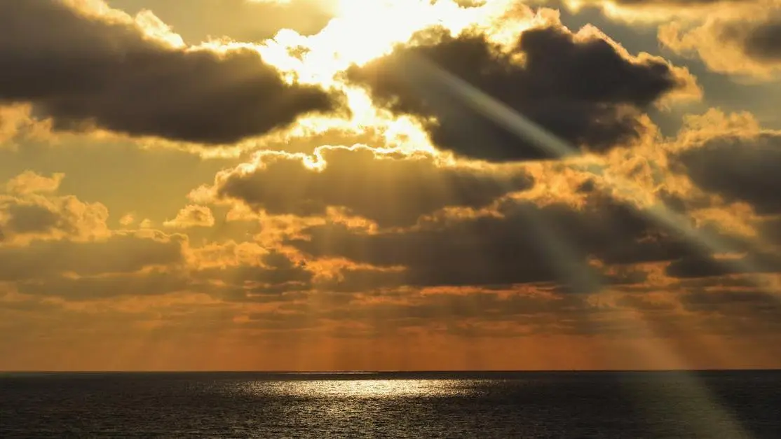 Sun rays over the ocean symbolizing menopause symptoms irritability