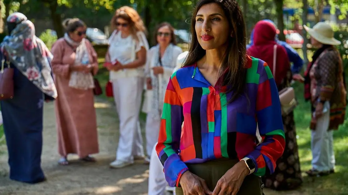 Smiling adult woman in park, illustrating Menopause vs Perimenopause.