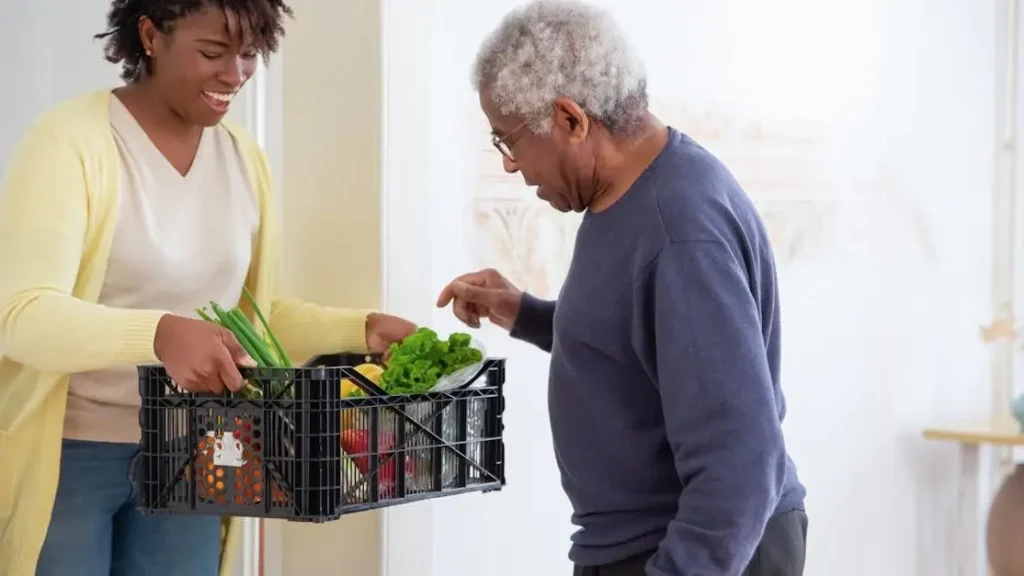 Woman holding crate of fruits and vegetables, showcasing mood helping vitamins.