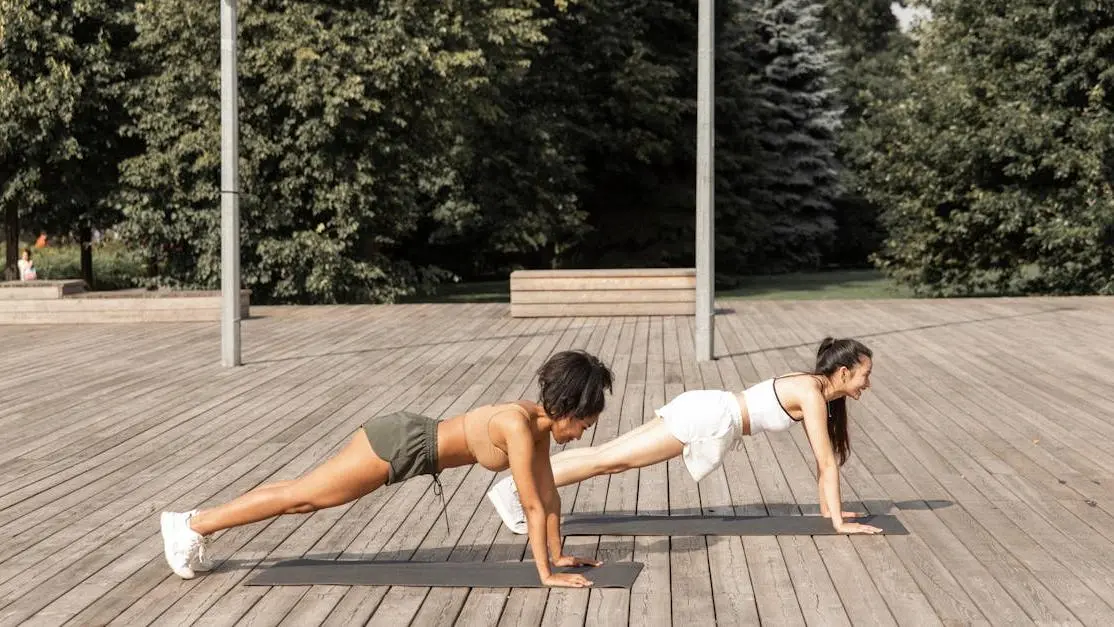 Women practicing yoga outdoors debunking the myth: All menopause treatments are hormonal.