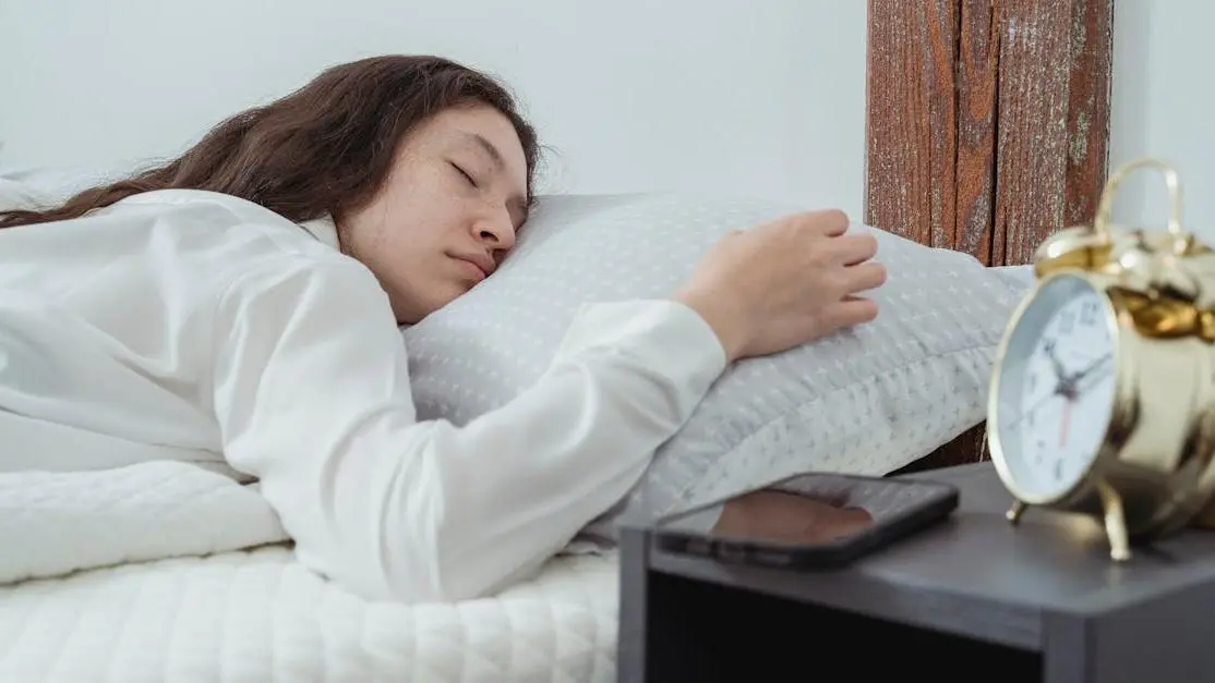 Woman sleeping peacefully on bed, illustrating sleep issues and menopause.