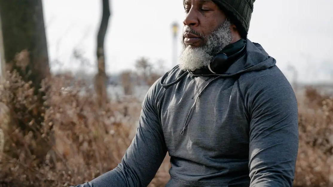 Man meditating in autumn, promoting supplements for hot flashes relaxation.