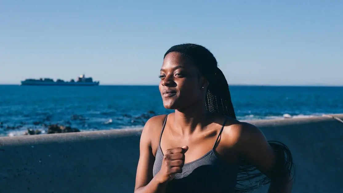 Woman jogging by the bay, addressing sweat rash from running