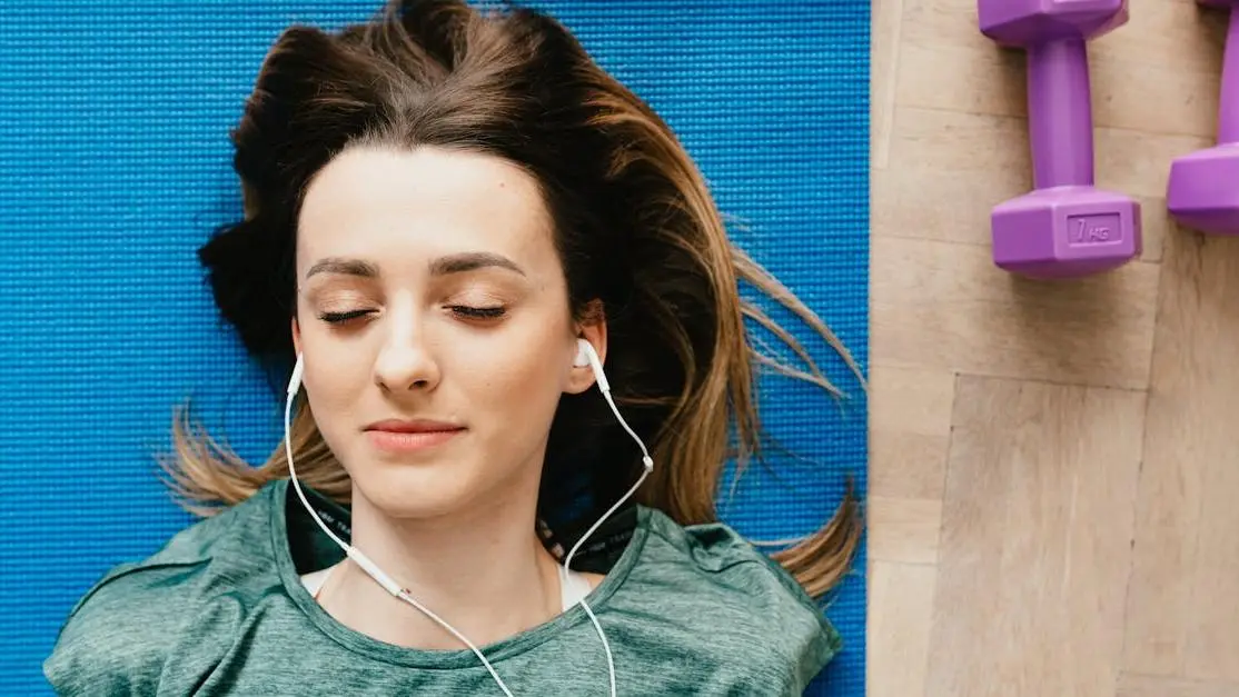 Woman resting after a workout, experiencing sweat rash in the groin area