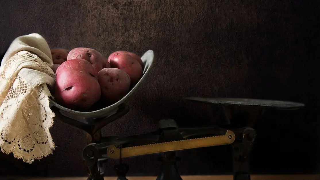 Sweet potatoes balancing on a black scale, representing weight gain and metabolism changes.