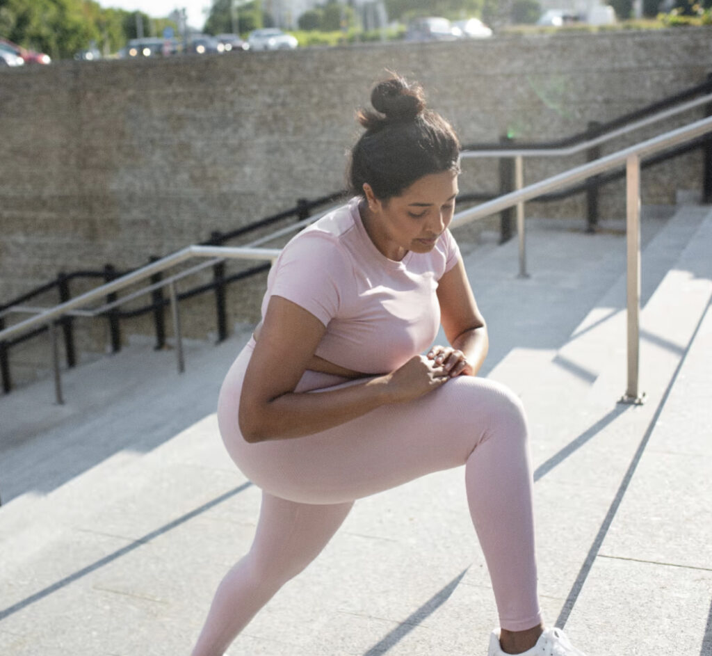 Woman stretching on stairs