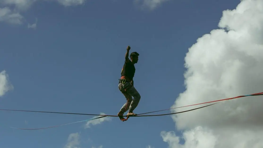 Man balancing on a slackline under dramatic sky, symbolizing GLP-1 Medications Help Maintain Weight Loss.